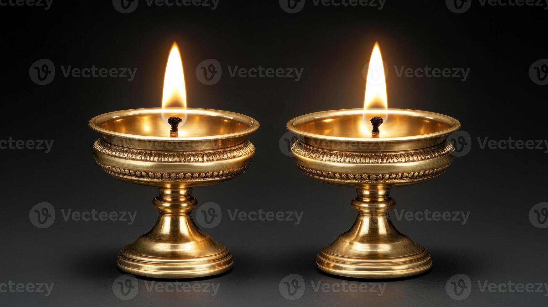 Two elegant gold candles with flames casting a warm, serene glow. photo