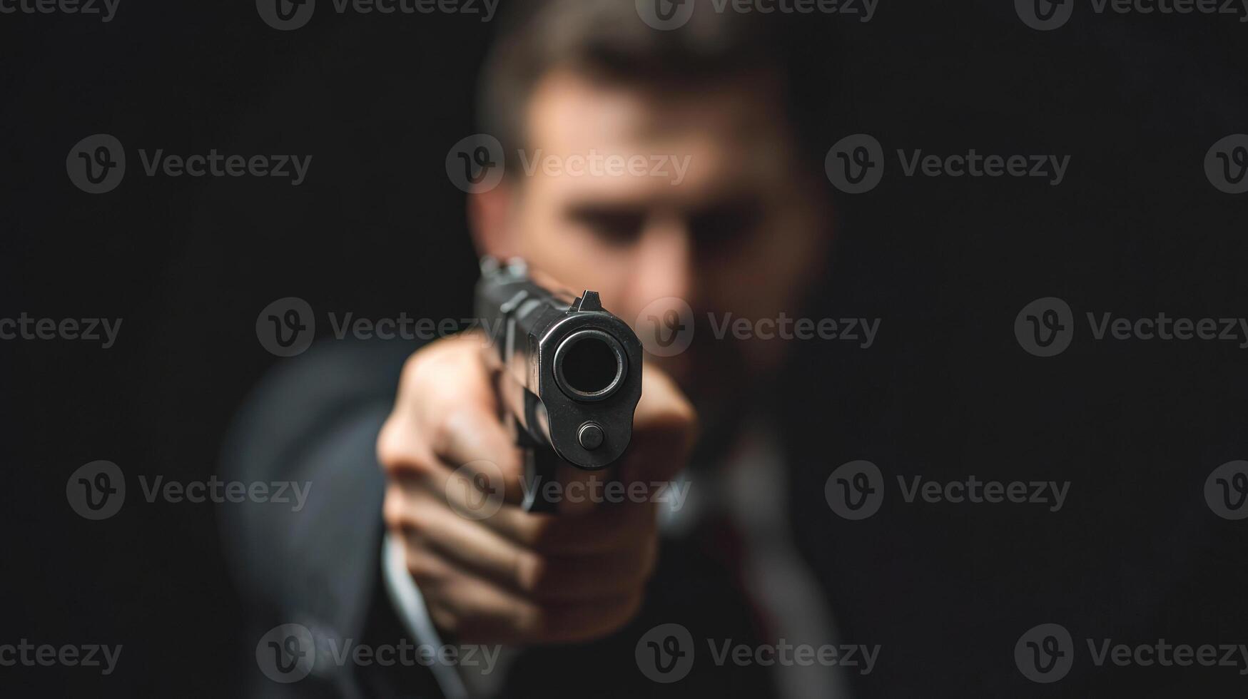 A man in a suit points a handgun, creating a tense atmosphere. photo