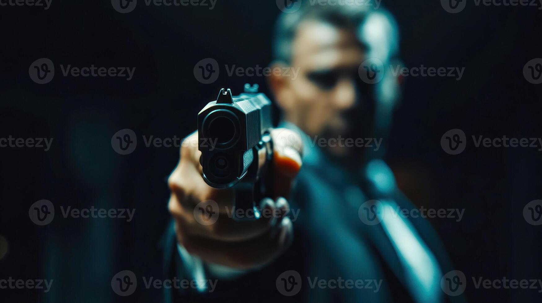 Focused portrait of a man aiming a handgun, creating a tense atmosphere. photo