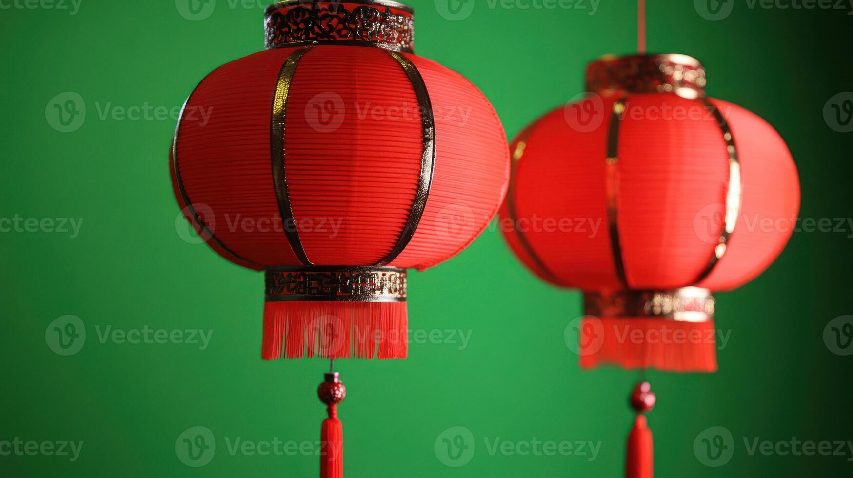 Red lanterns hanging against a vibrant green background. photo