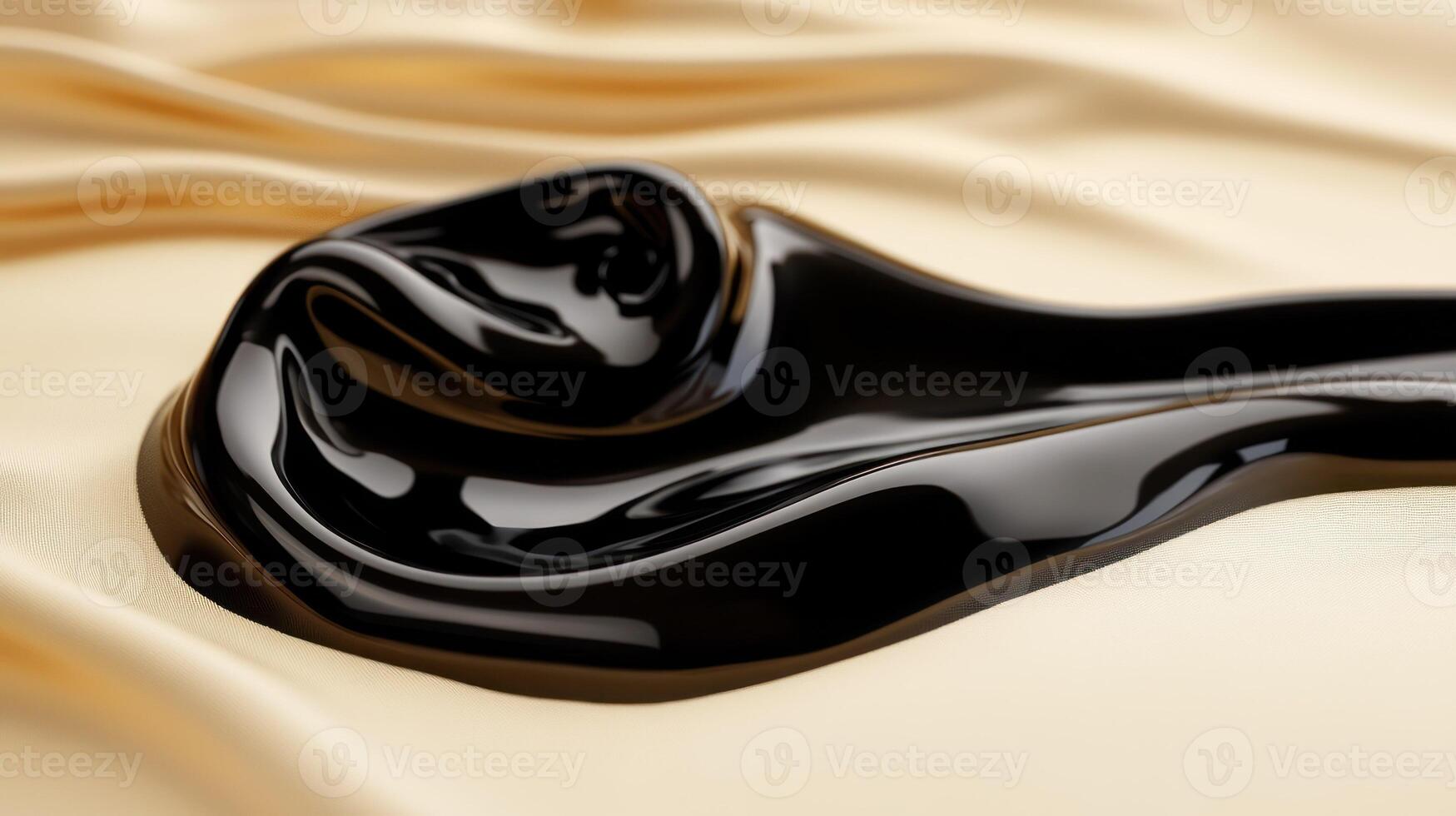 A glossy black fluid elegantly spreads over a smooth fabric surface. photo