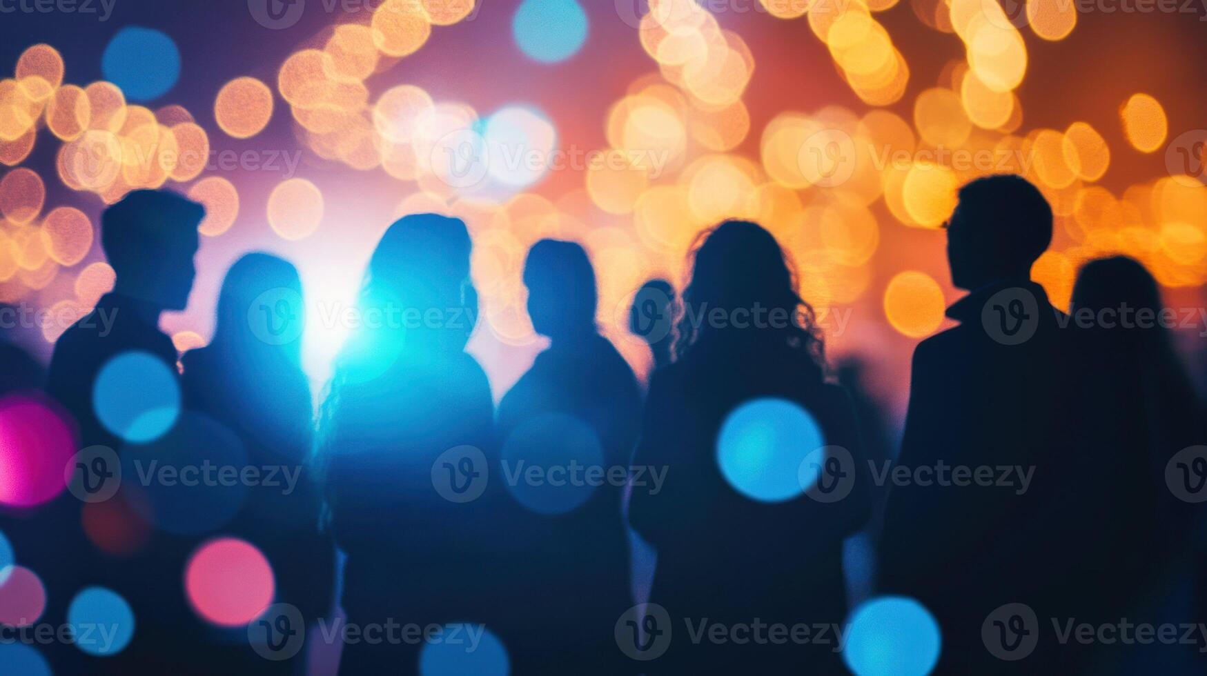 Silhouettes of people against a colorful bokeh backdrop. photo