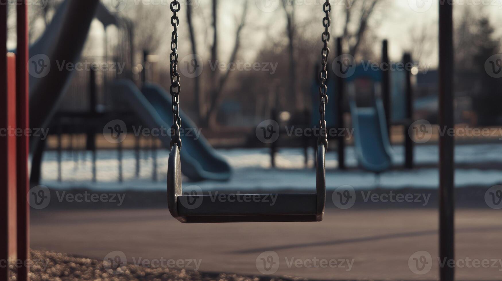 An empty swing in a quiet playground hinting at childhood nostalgia. photo