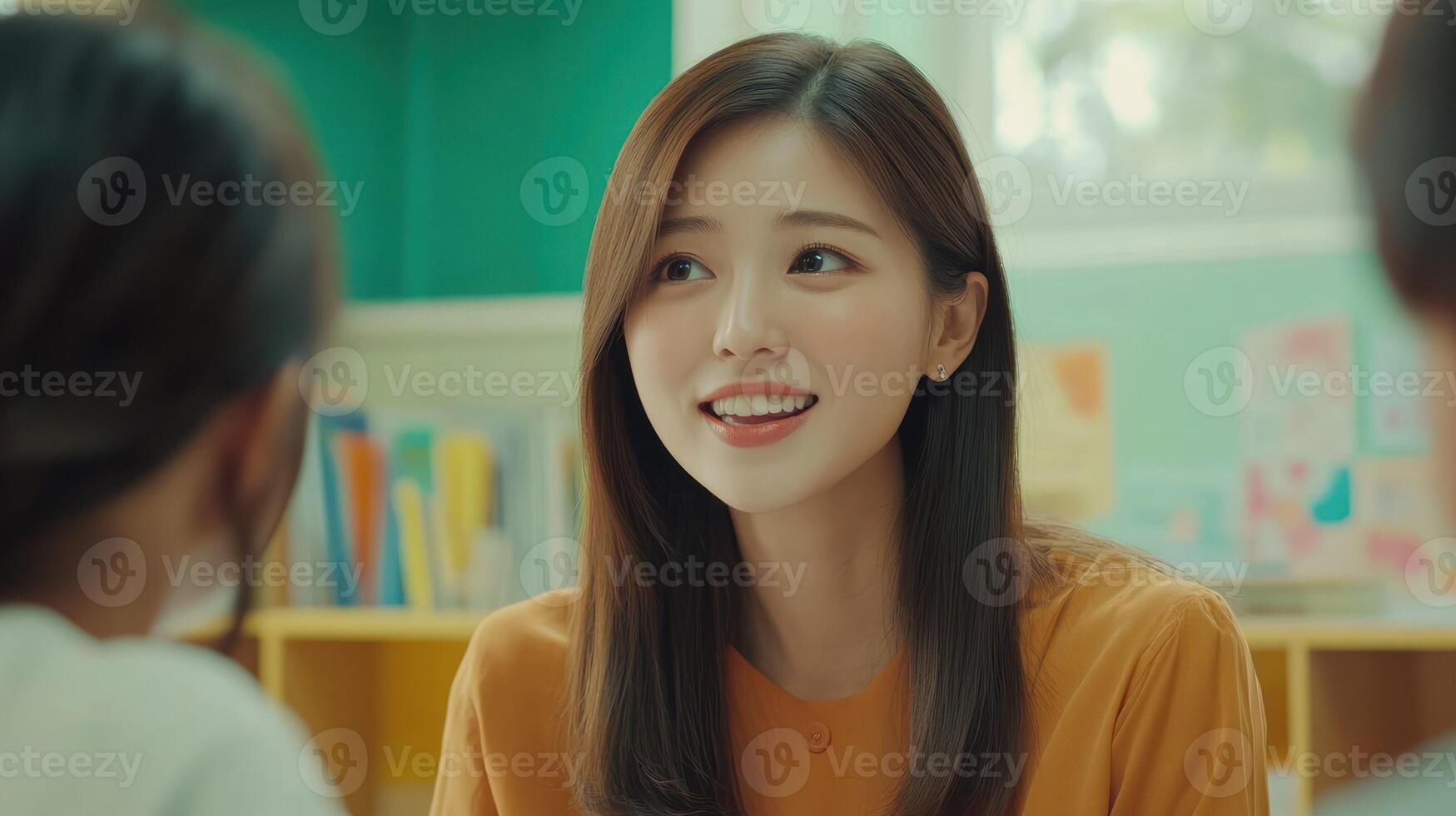 A cheerful woman engages warmly in a classroom discussion. photo