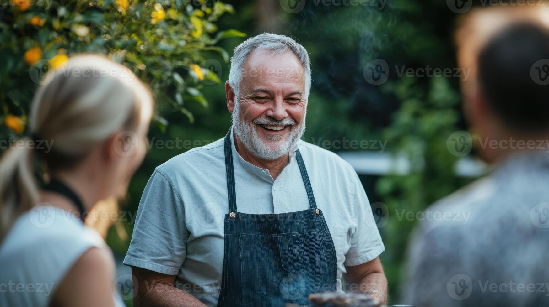 A smiling chef grilling outdoors, surrounded by joyful friends. photo