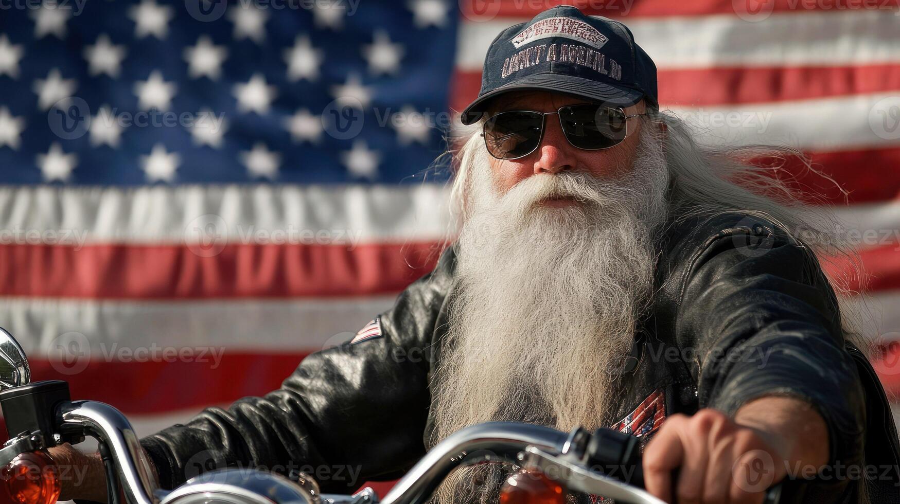 A seasoned biker in sunglasses poses confidently against an American flag. photo