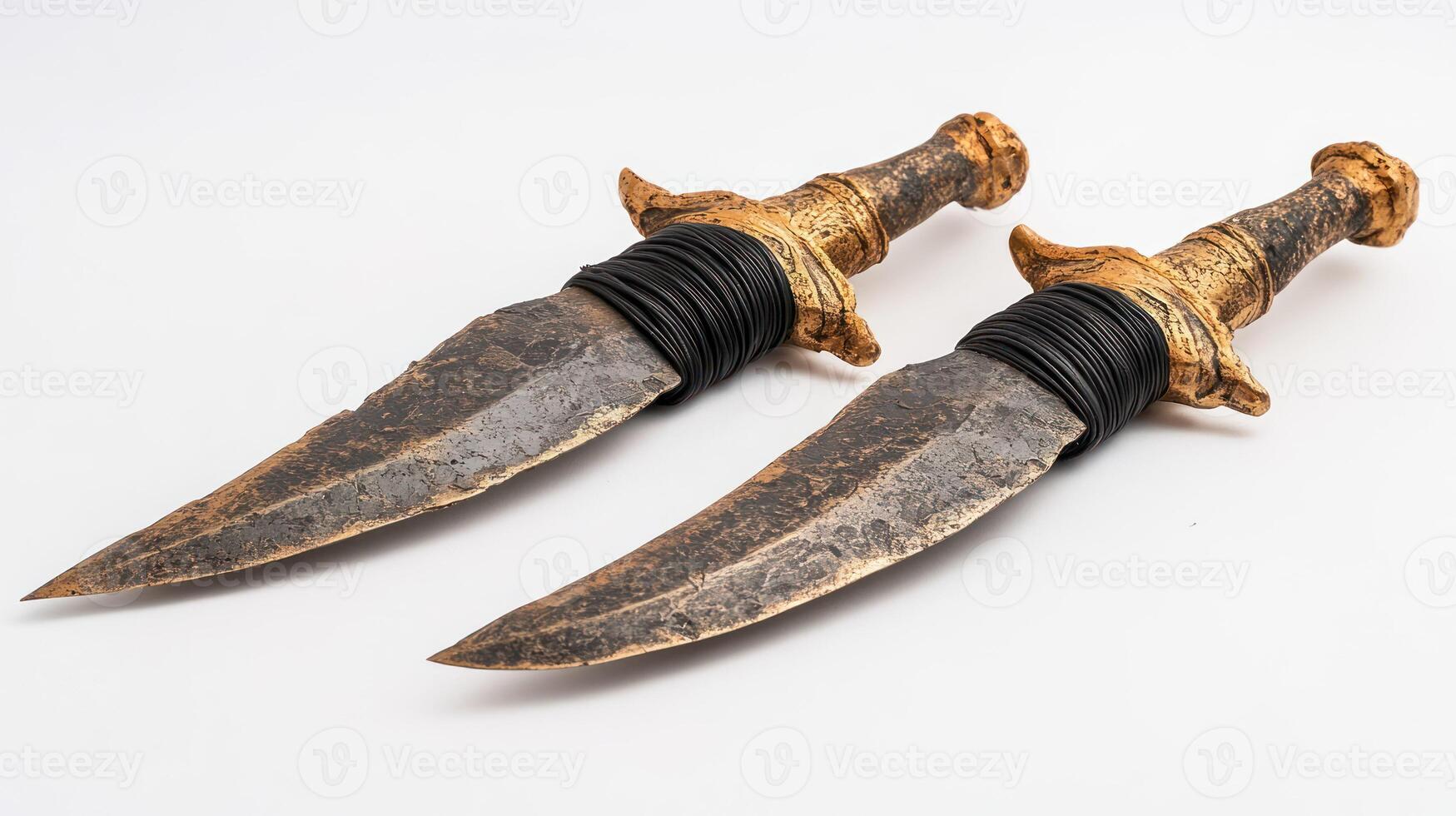 Two ornate antique daggers with intricate handles and sharp blades. photo