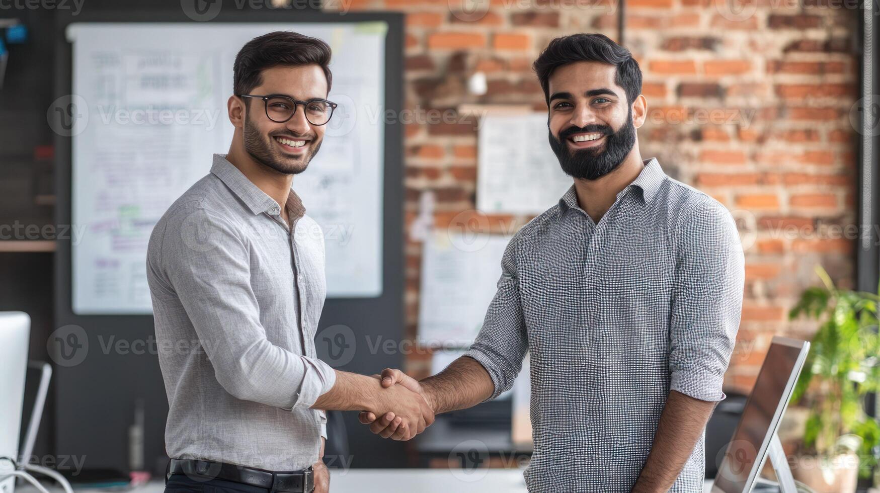 Two professionals shaking hands in a modern office environment. photo