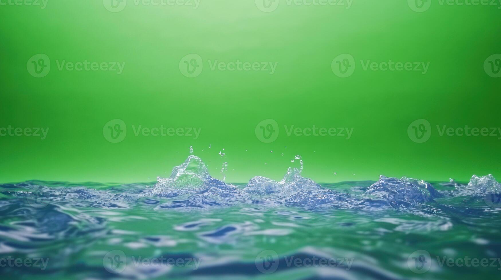 Rippling water with splashes against a vibrant green background. photo