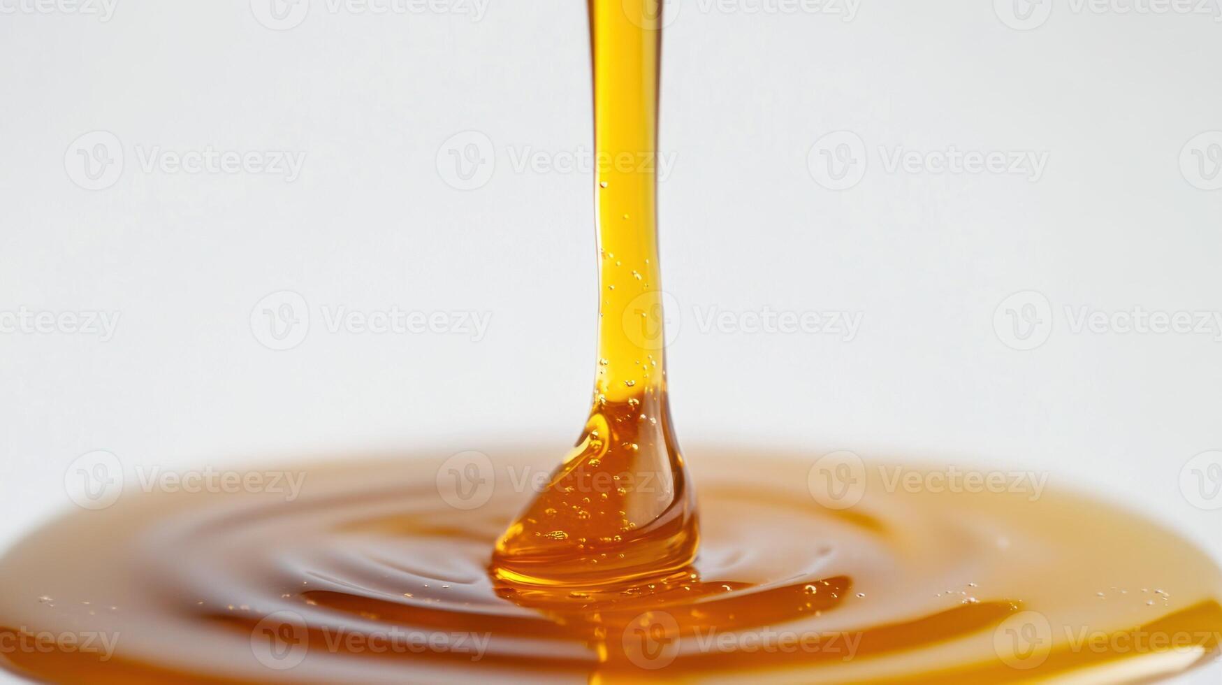 Golden syrup flows smoothly, creating a glossy texture. photo