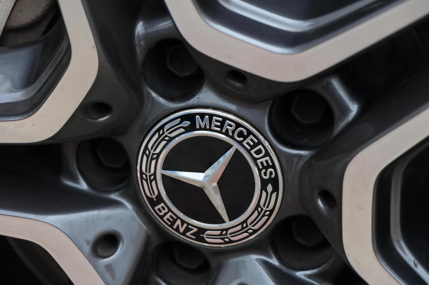 Gaziveren Cyprus -17.03.2025 Mercedes-AMG Symbol of elegance and power captured in a close-up of a luxury car's wheel at a vibrant urban setting during the golden hour photo
