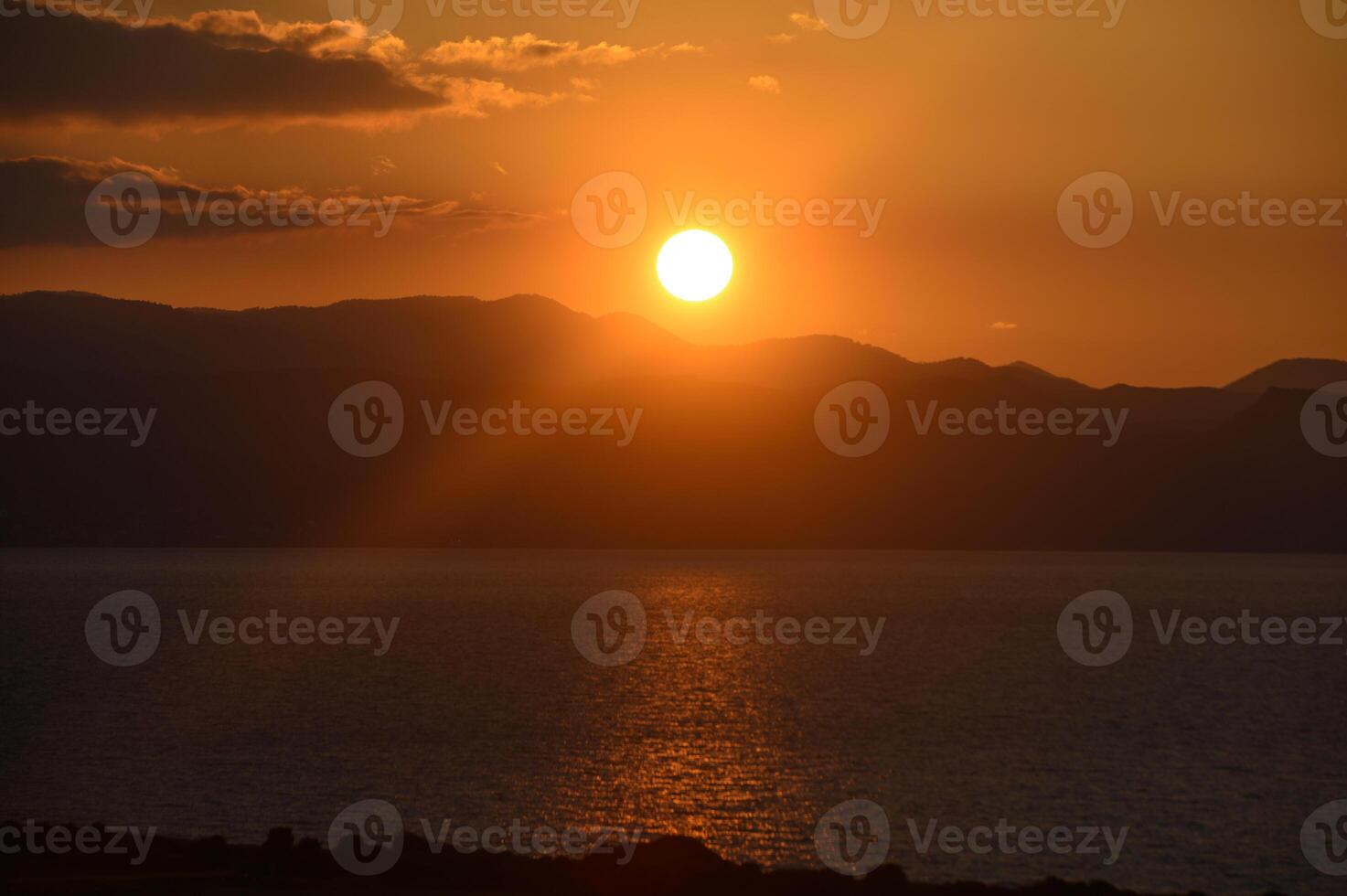 Breathtaking sunset over tranquil lake reflecting golden hues of twilight photo