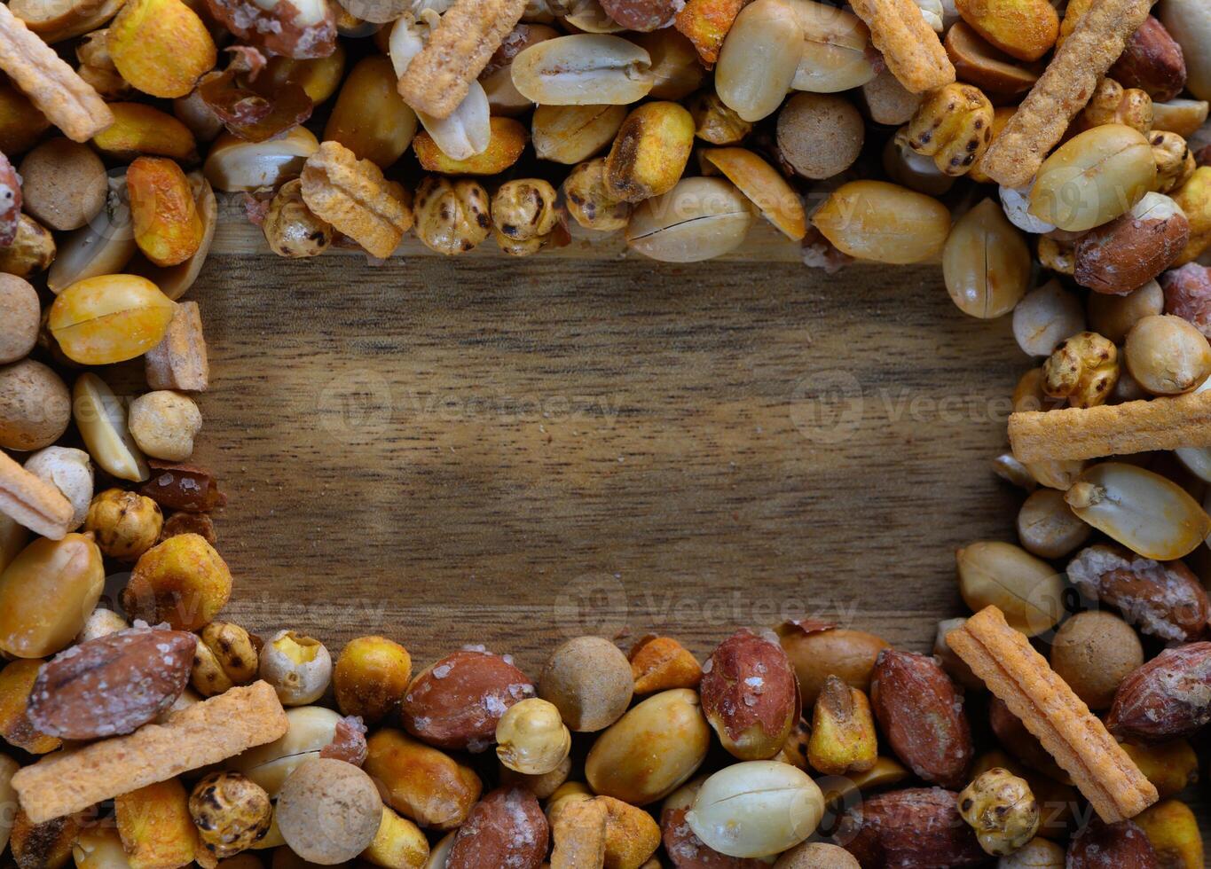Colorful assortment of snacks arranged creatively on a wooden surface during a social gathering photo