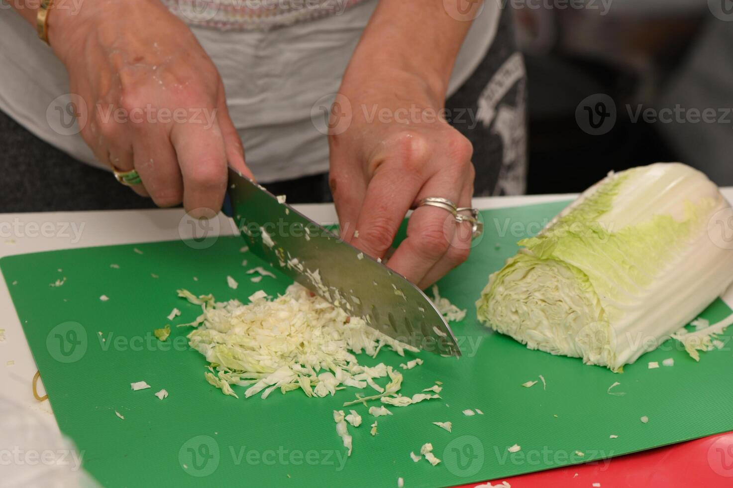 Chopping fresh cabbage for a delicious meal in a cozy kitchen during a vibrant cooking class photo