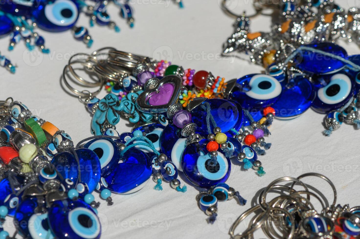 Colorful blue ceramic charms and jewelry displayed at a vibrant craft market in midday sunlight photo