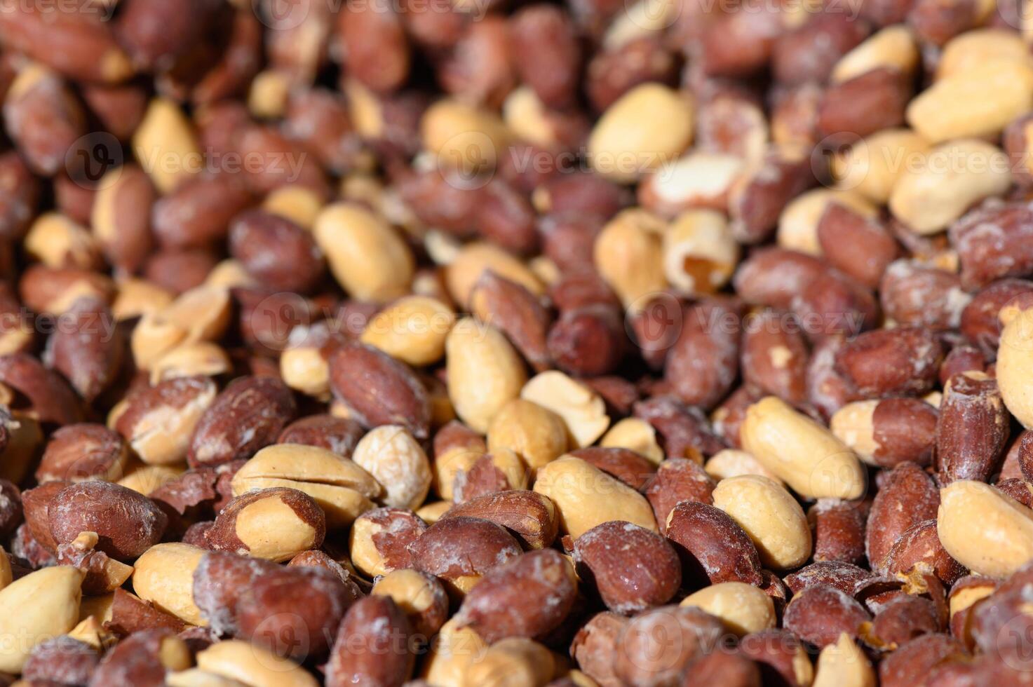 Vibrant assortment of nuts basking in warm sunlight during a bustling market afternoon photo