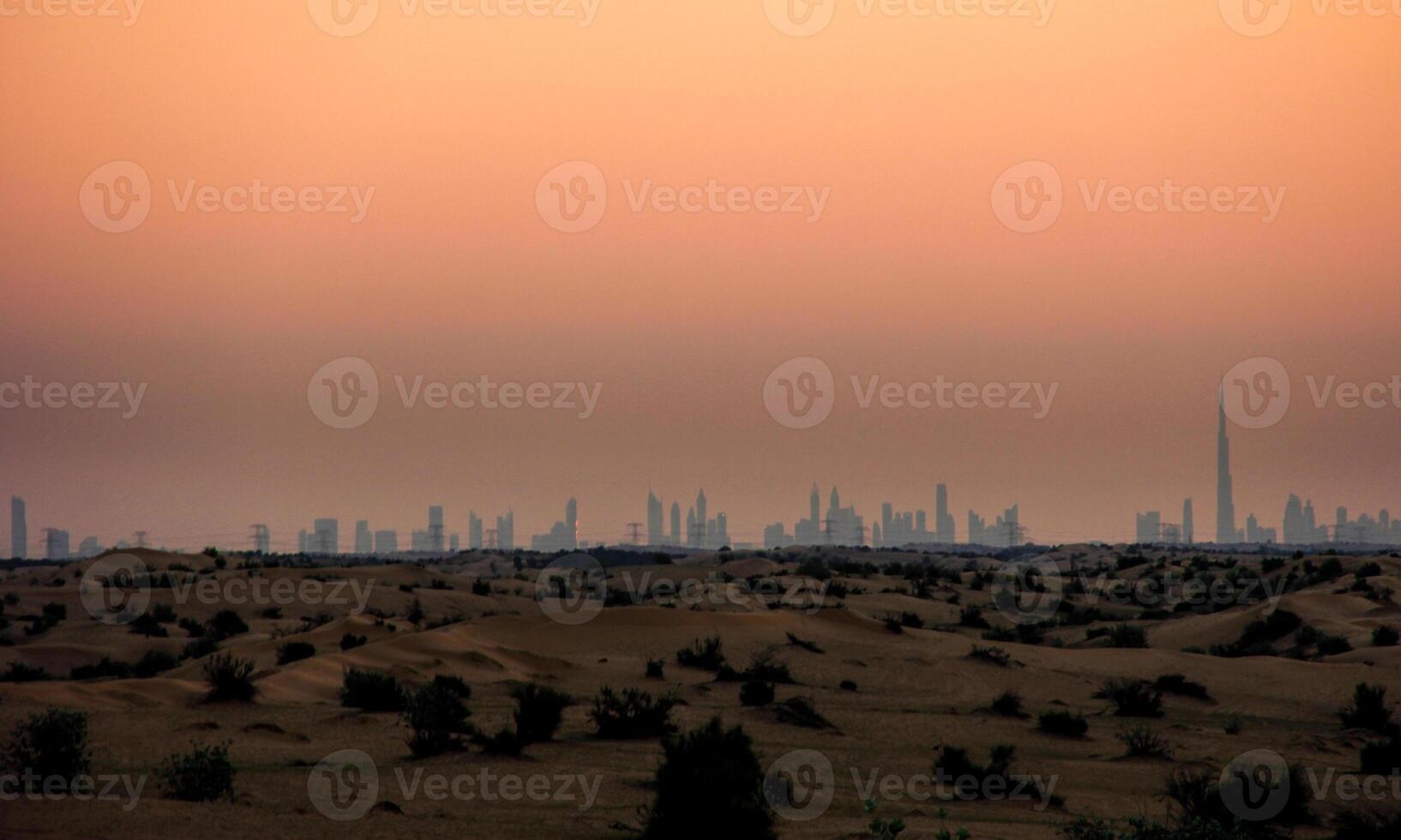 The skyline of dubai at sunset photo