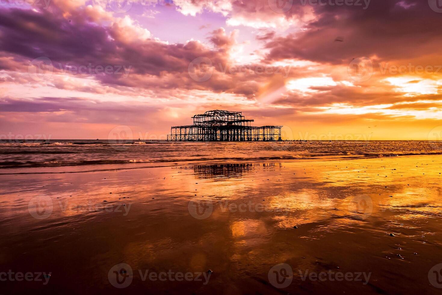 The west pier at sunset in brighton, england photo
