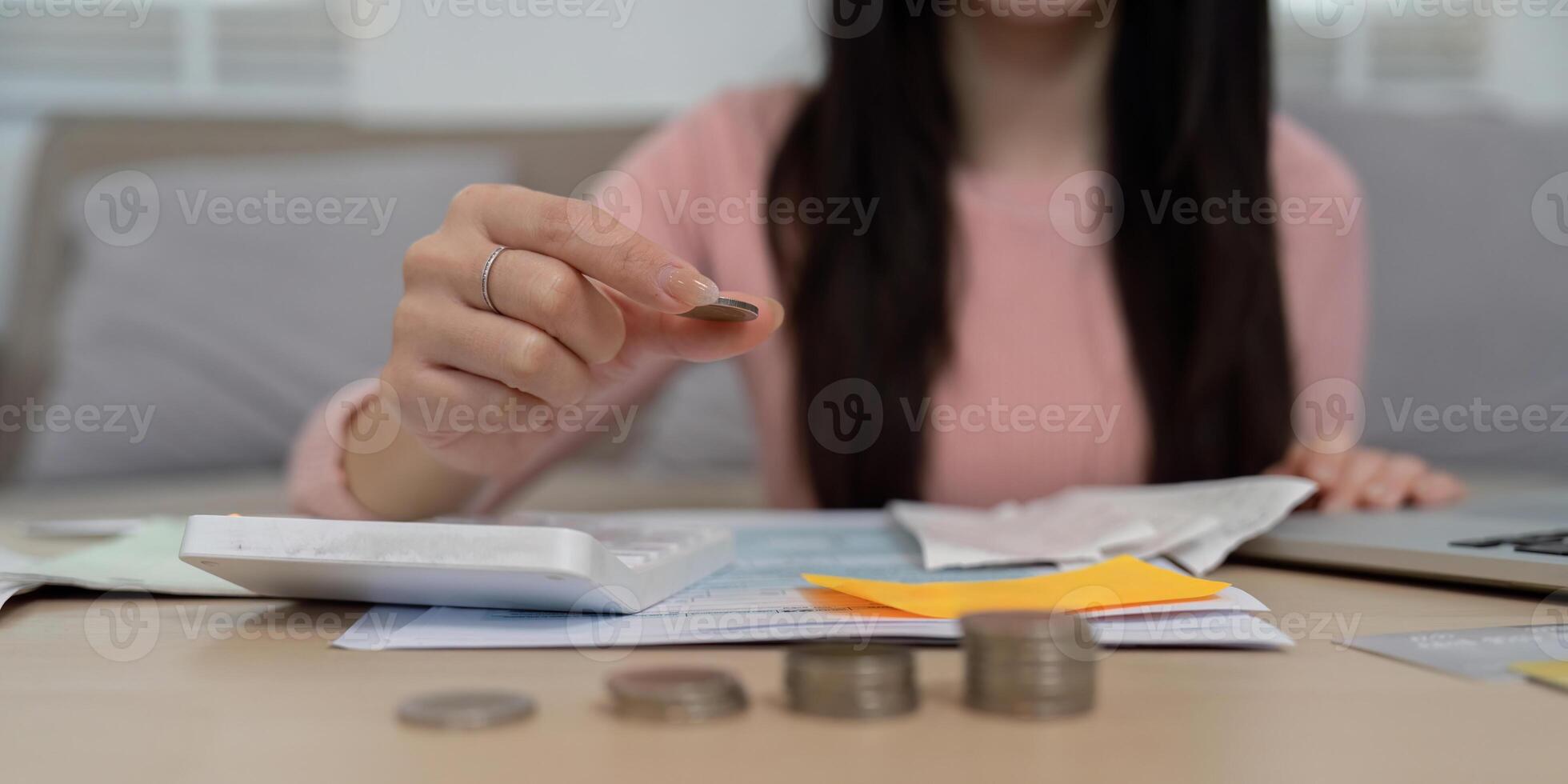 Money Management and Coin Counting. A woman takes a moment to focus on her finances by counting coins on a table. photo