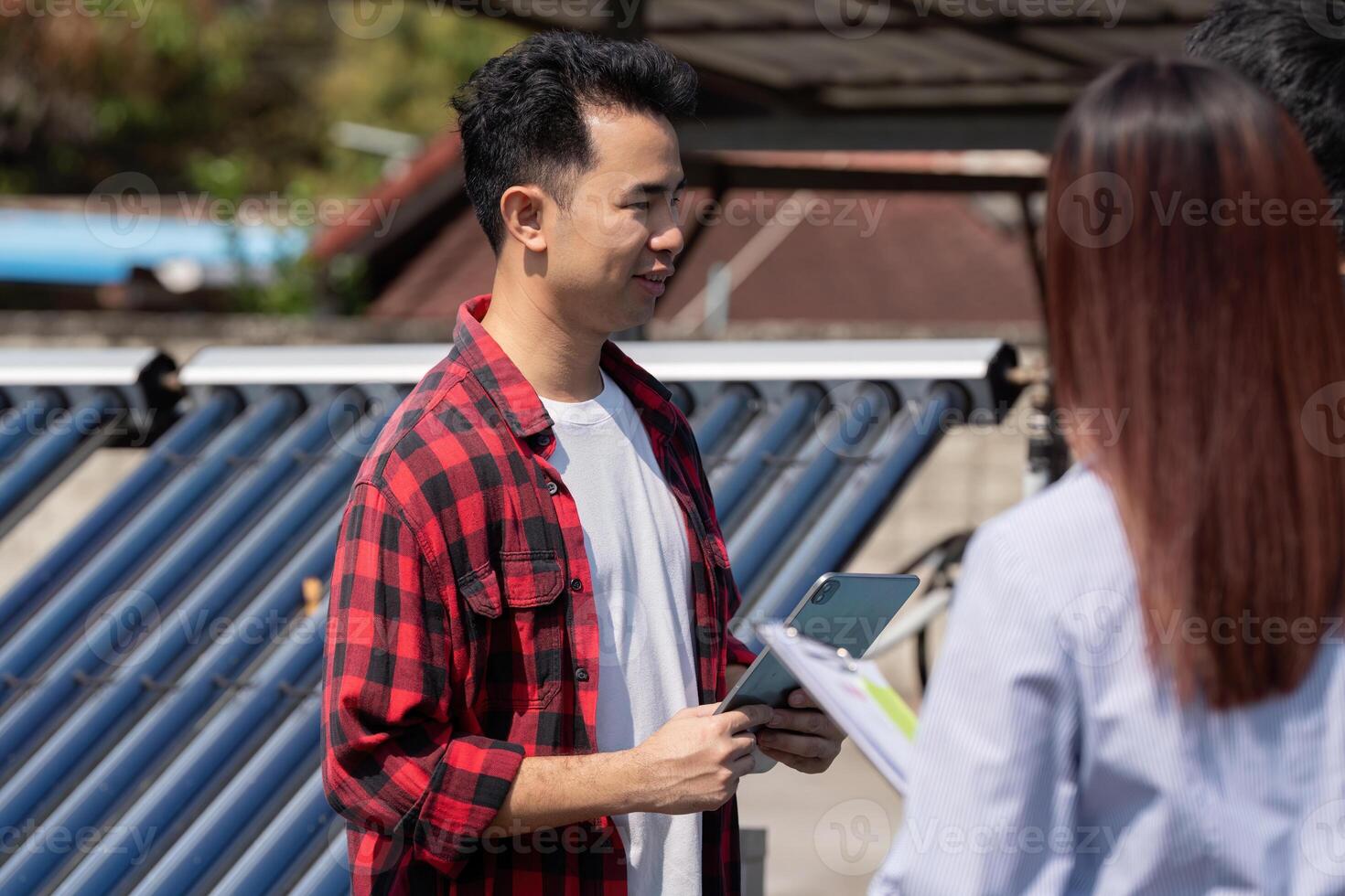 Client Interaction and Solar Energy Education. A technician shares insights on solar energy with clients during a site visit. photo