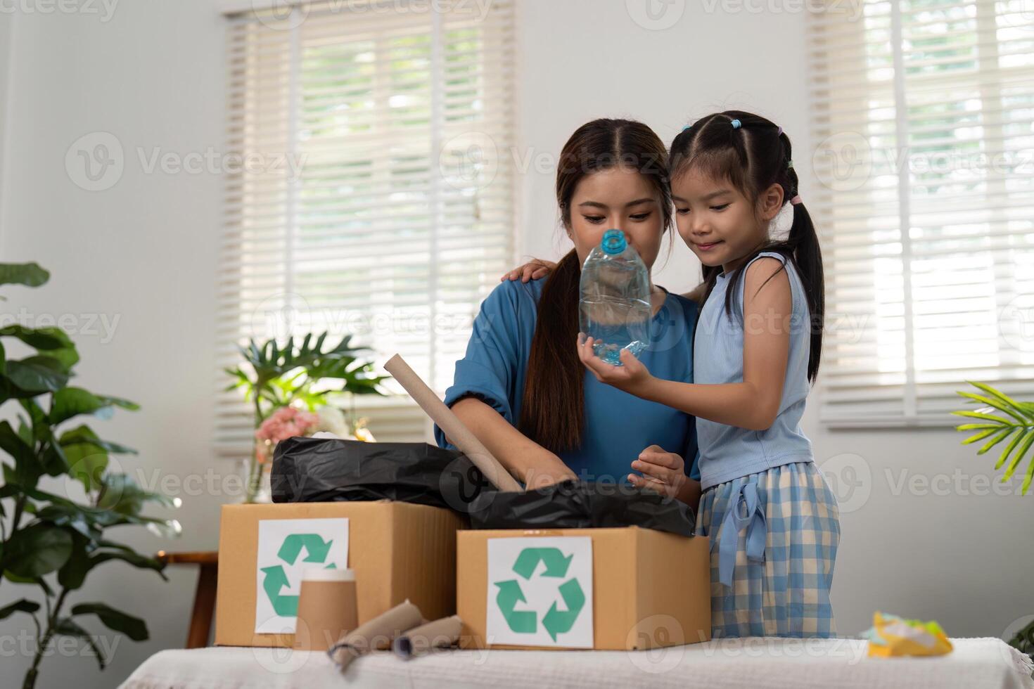 Recycling and Childhood Learning. A mother and daughter explore recycling practices, creating memories while sorting waste. photo