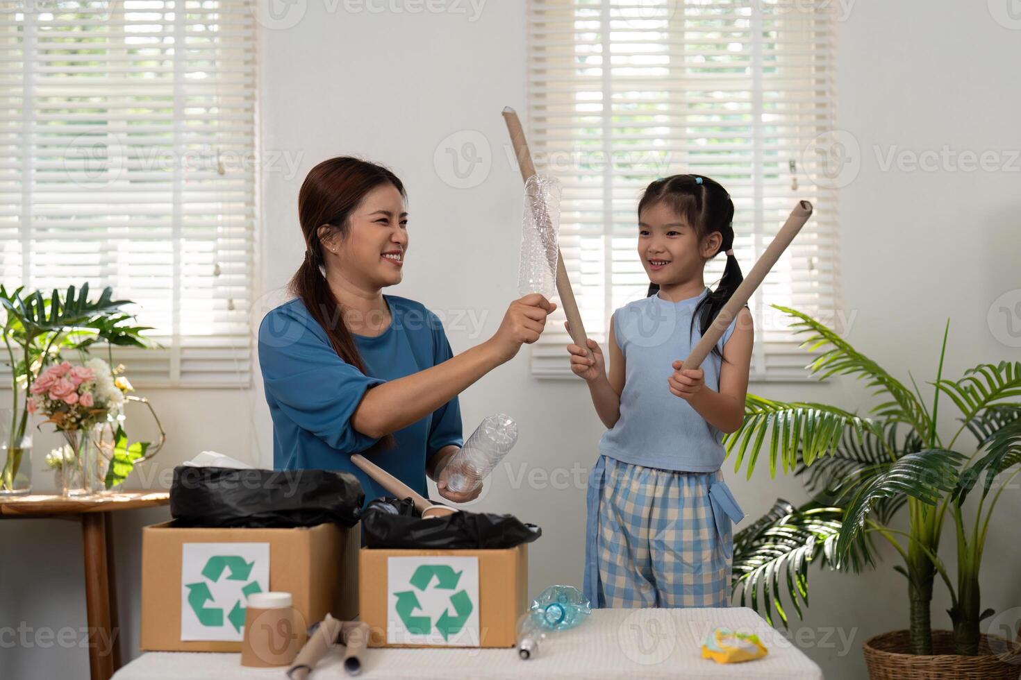 Eco-consciousness and Creativity. Engaging in recycling, a mother and daughter create lasting memories while promoting eco-friendliness. photo
