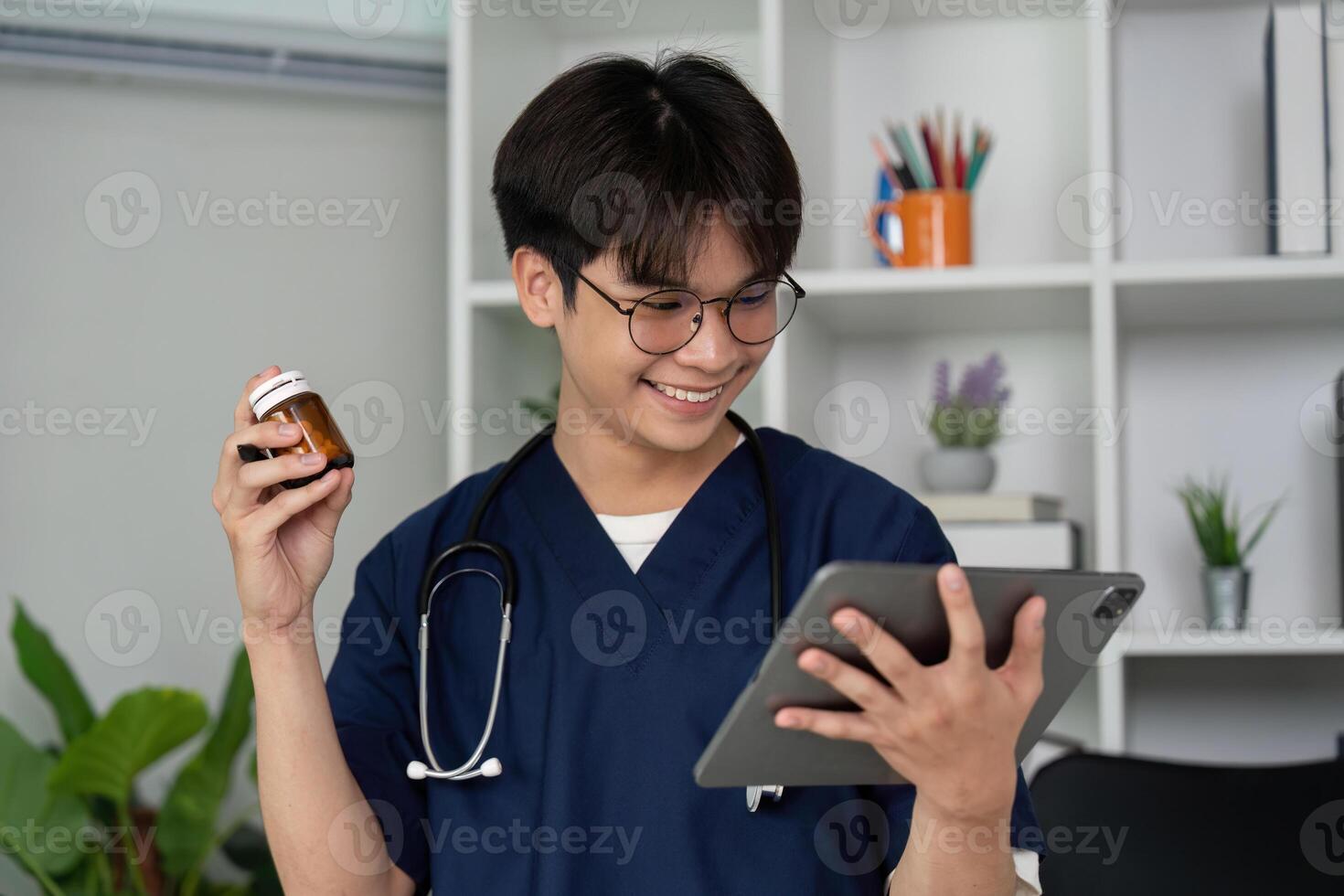 Engagement and Learning. A medical student smiling while using a tablet for medication management. photo