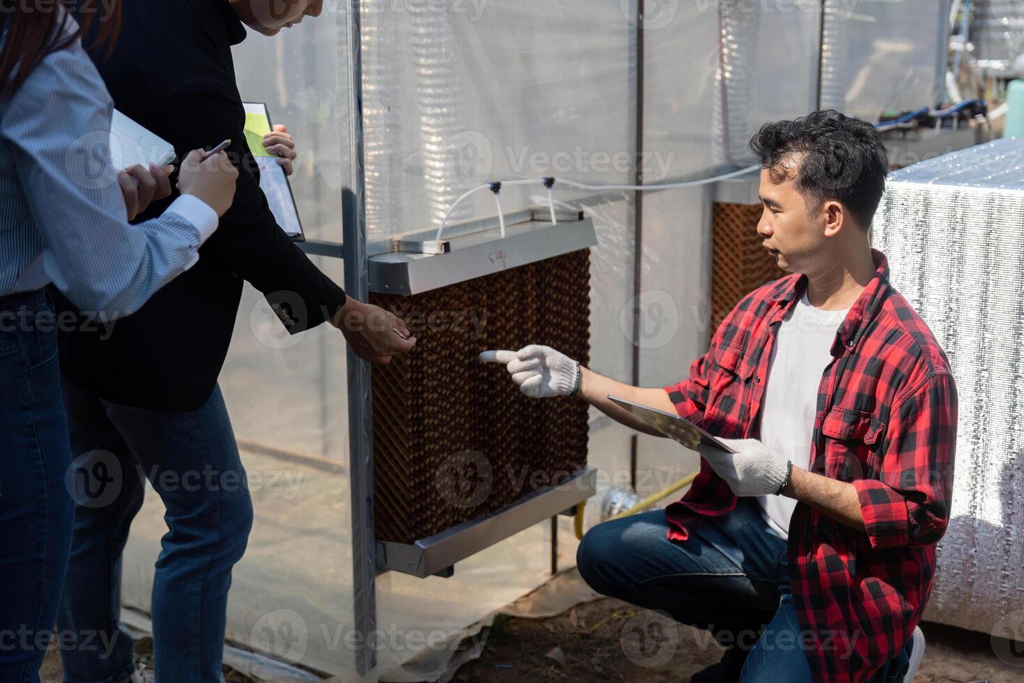 Engagement and Renewable Energy Innovation. A contractor shows a team of professionals the application of solar technology in a sustainable project. photo