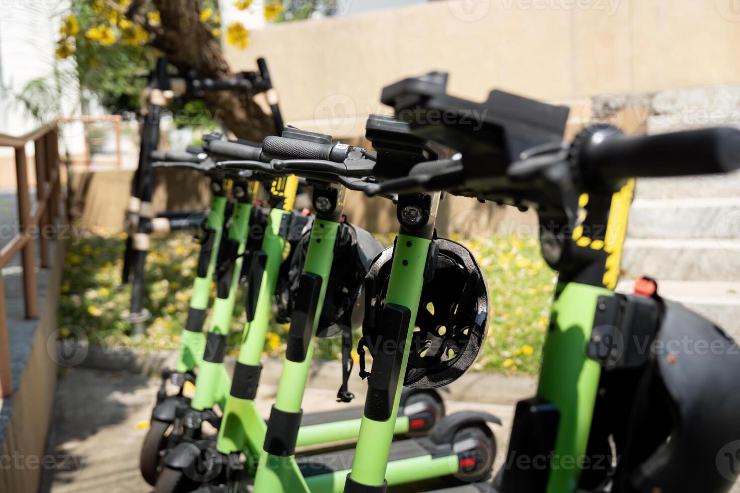 E-Scooter and Green Transport. A row of electric scooters parked in an urban area, promoting eco-friendly transportation. photo