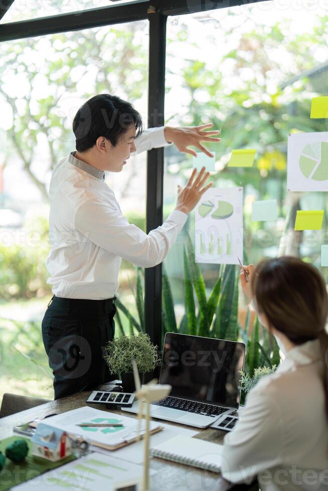 Presentation and Engagement. A professional presenting sustainable development ideas with visuals. photo