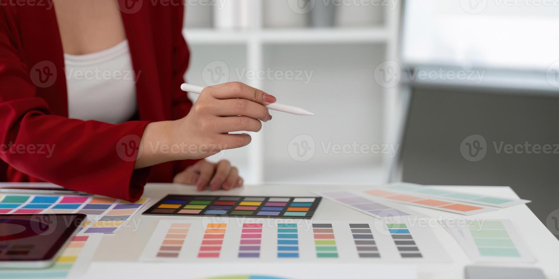 Color Theory and Graphic Design. A graphic designer focuses on a range of color swatches. photo