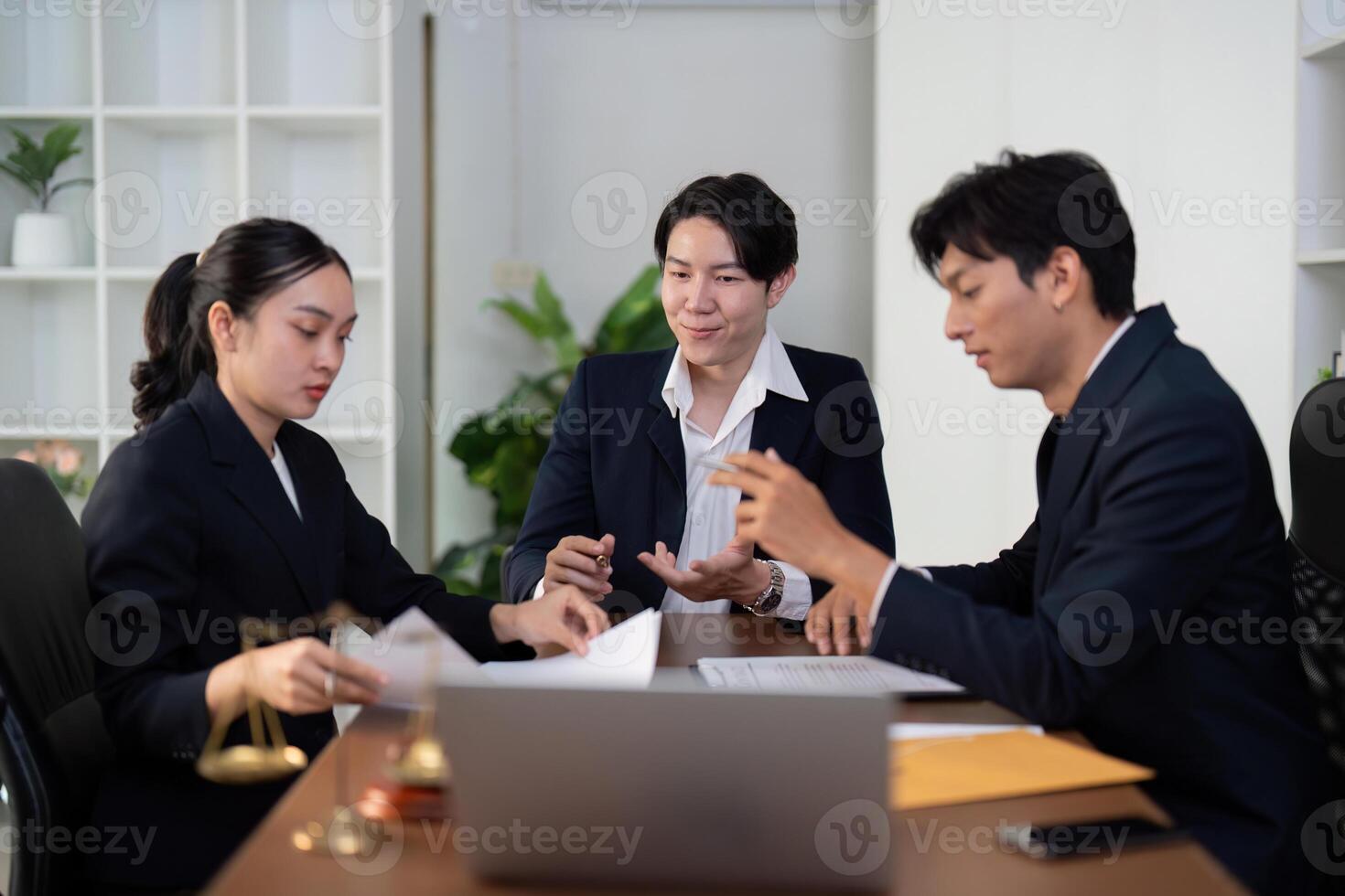Team Collaboration and Legal Discussion. A group of attorneys working together on client cases. photo
