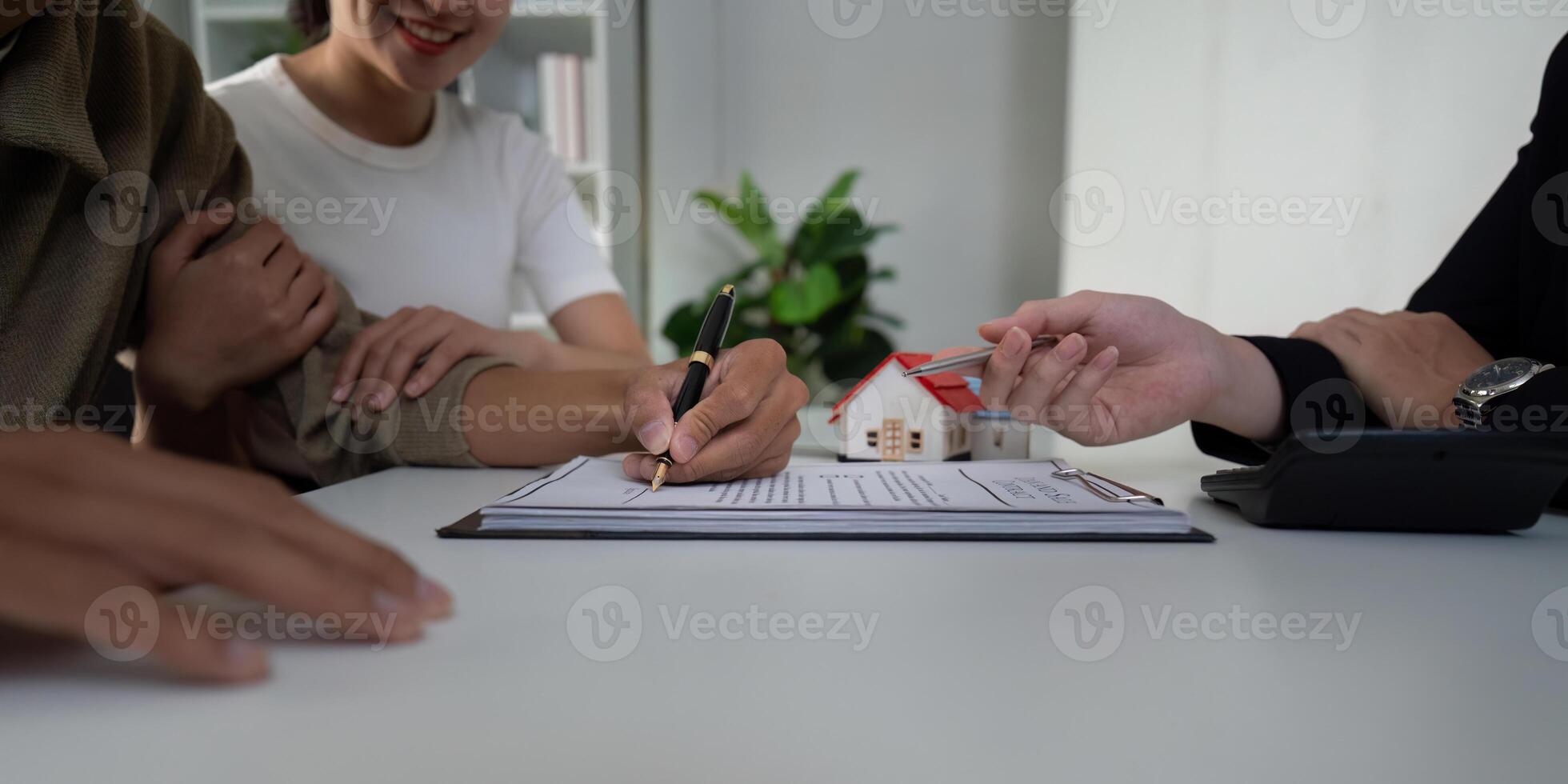 Real Estate and Partnership. A couple engaging with their real estate agent to finalize a home purchase. photo