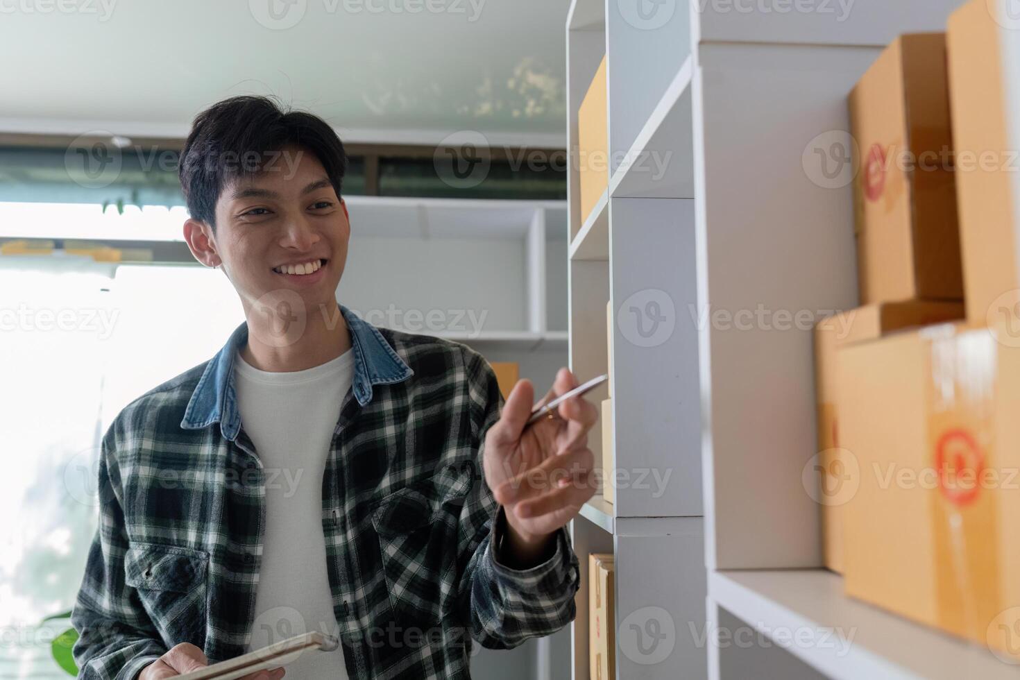 Entrepreneurship and Stock Management. A young man checking inventory for his online store. photo