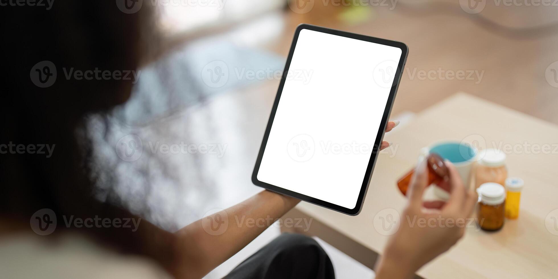 Telemedicine and Digital Health Management. A patient utilizing a digital device to manage medications at home, emphasizing telehealth's convenience. photo