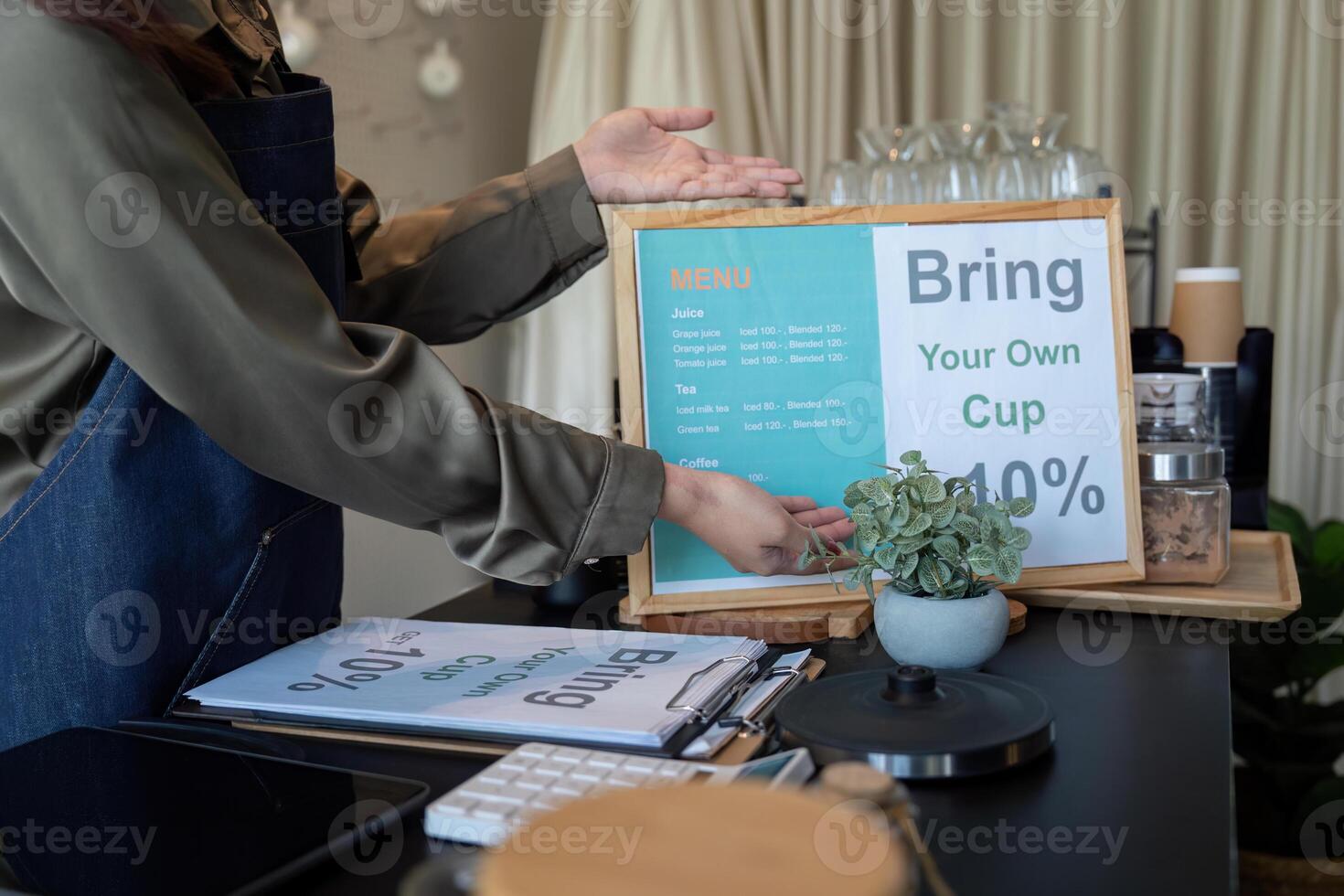 Sustainable Practices and Eco-Friendly Initiatives. A cafe promoting the bring-your-own-cup policy to encourage sustainability. photo