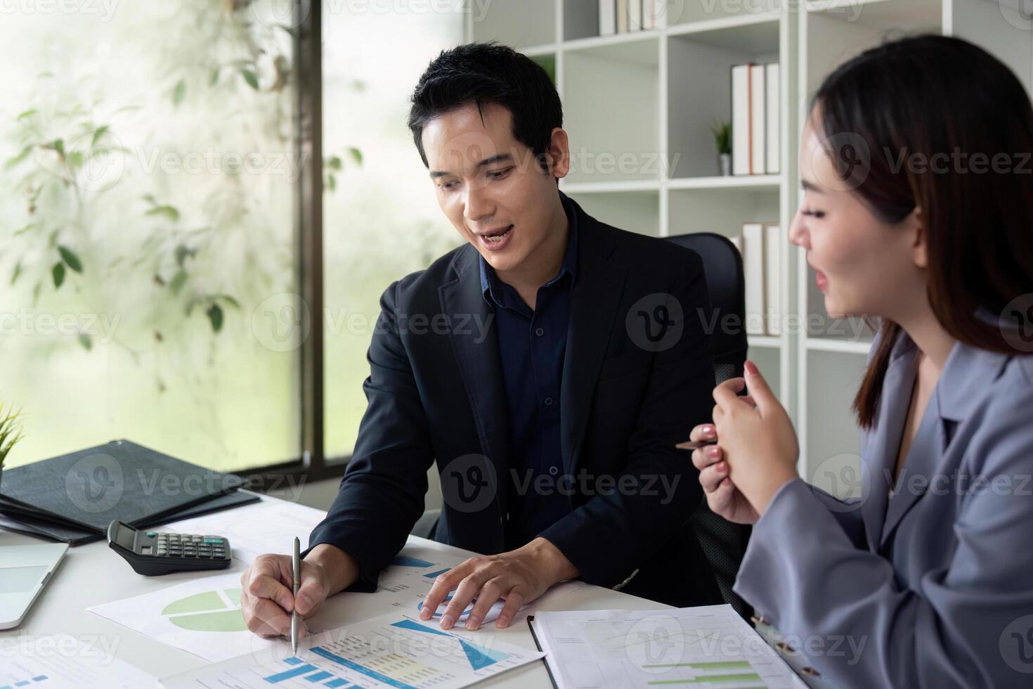 Professional Consultation and Data Presentation. Colleagues engaged in a lively discussion about data insights. photo
