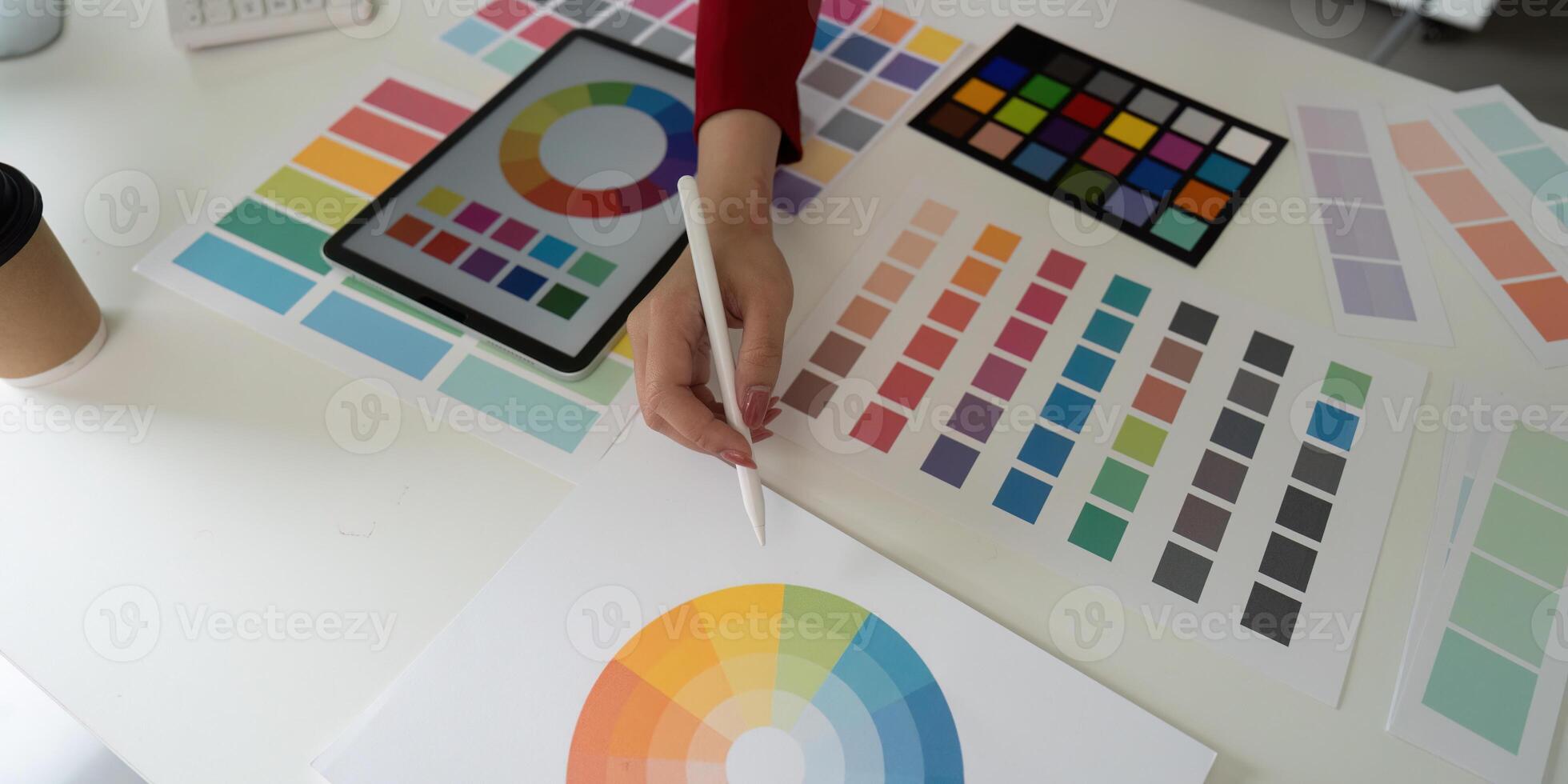 Color Selection and Digital Creation. An artist's hand selects color swatches for creative projects. photo