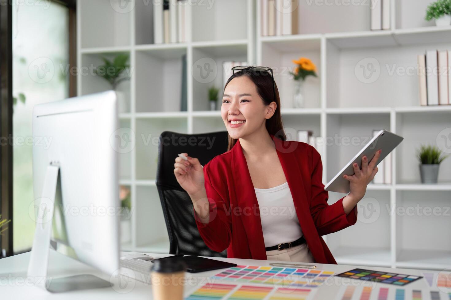 Joy in Design and Collaboration. A graphic designer celebrating a breakthrough with her tablet in hand. photo