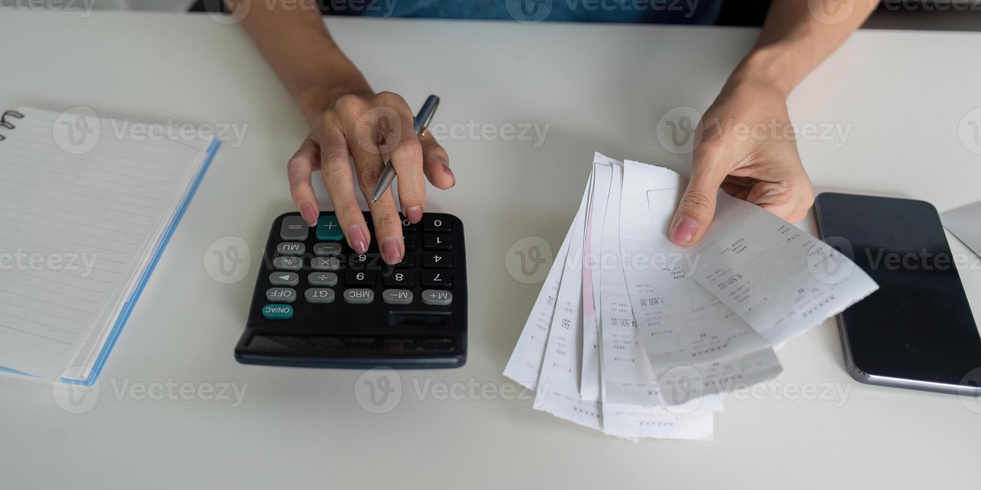 Budgeting and Expense Tracking. A person calculating expenses with receipts and a calculator, focusing on financial responsibility. photo