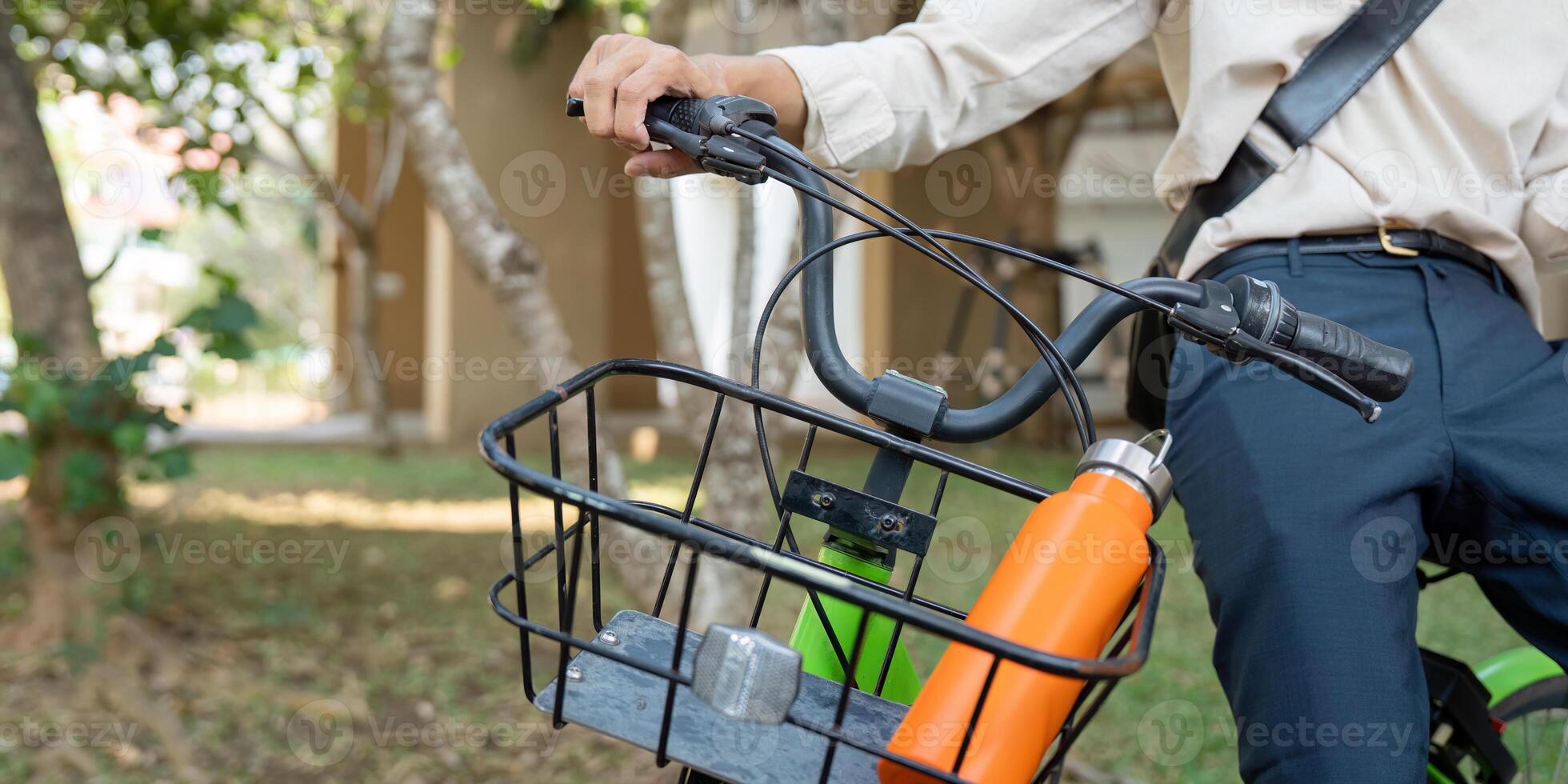 Eco-Friendly Commuting and Cycling. A person riding a bicycle equipped with a basket for carrying essentials. photo