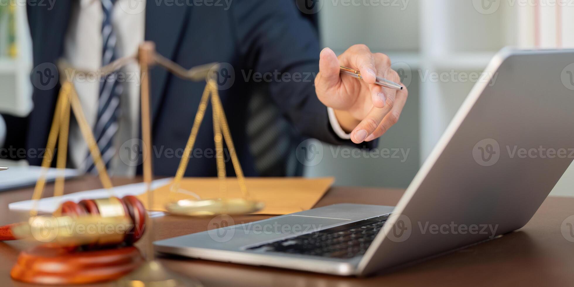 Law and Technology. A lawyer discussing strategies while pointing to a laptop. photo