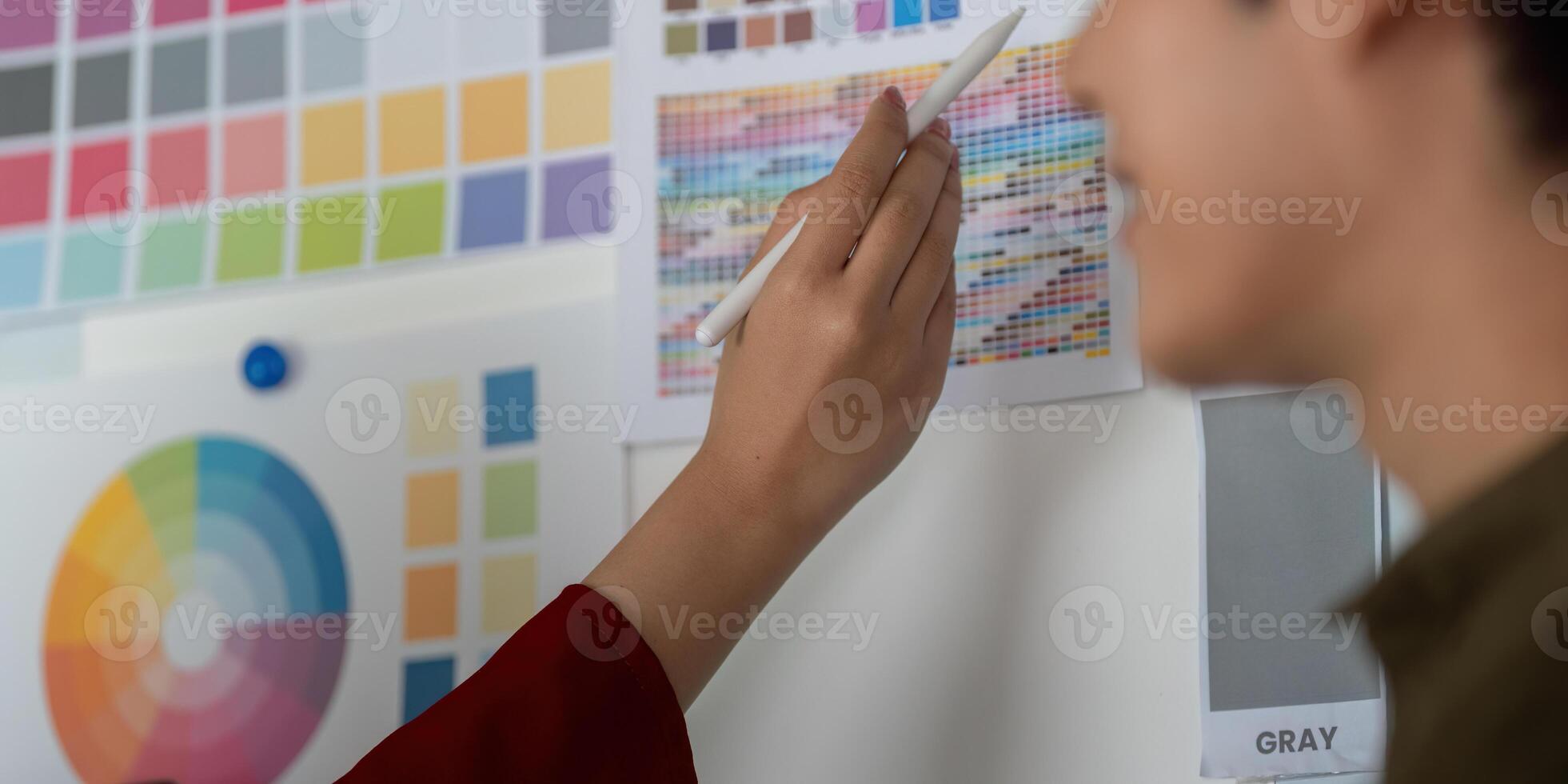 Creative Ideation and Color Selection. Team member selects colors from a comprehensive palette for a project. photo