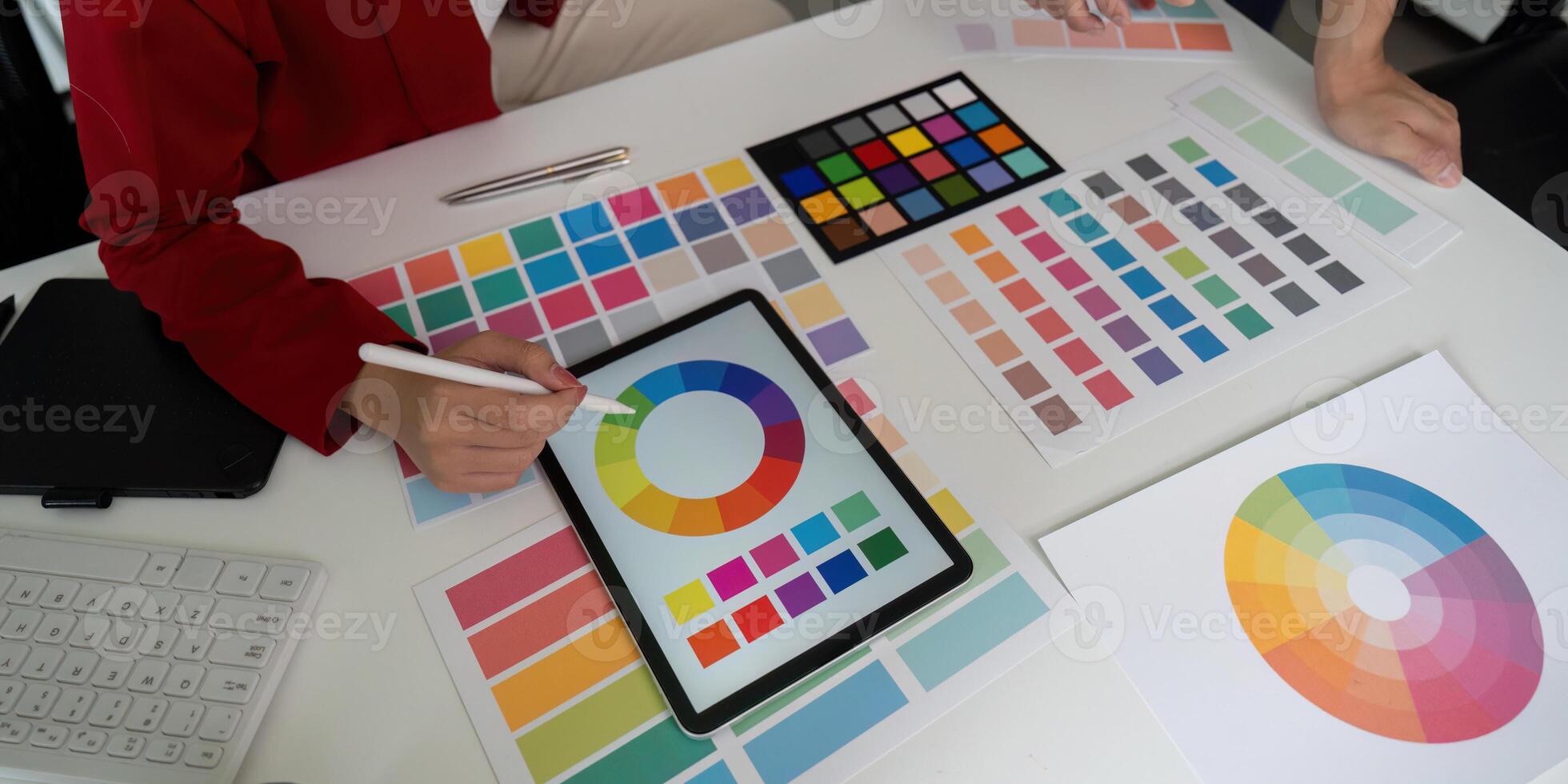 Color Selection and Design Collaboration. A designer selects colors while sharing insights with a colleague. photo
