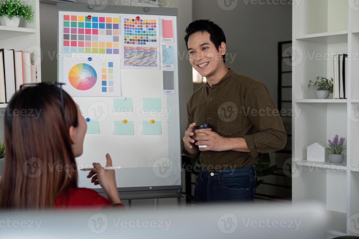 Team Collaboration and Creativity. A graphic design team brainstorming and discussing color palettes for a project. photo