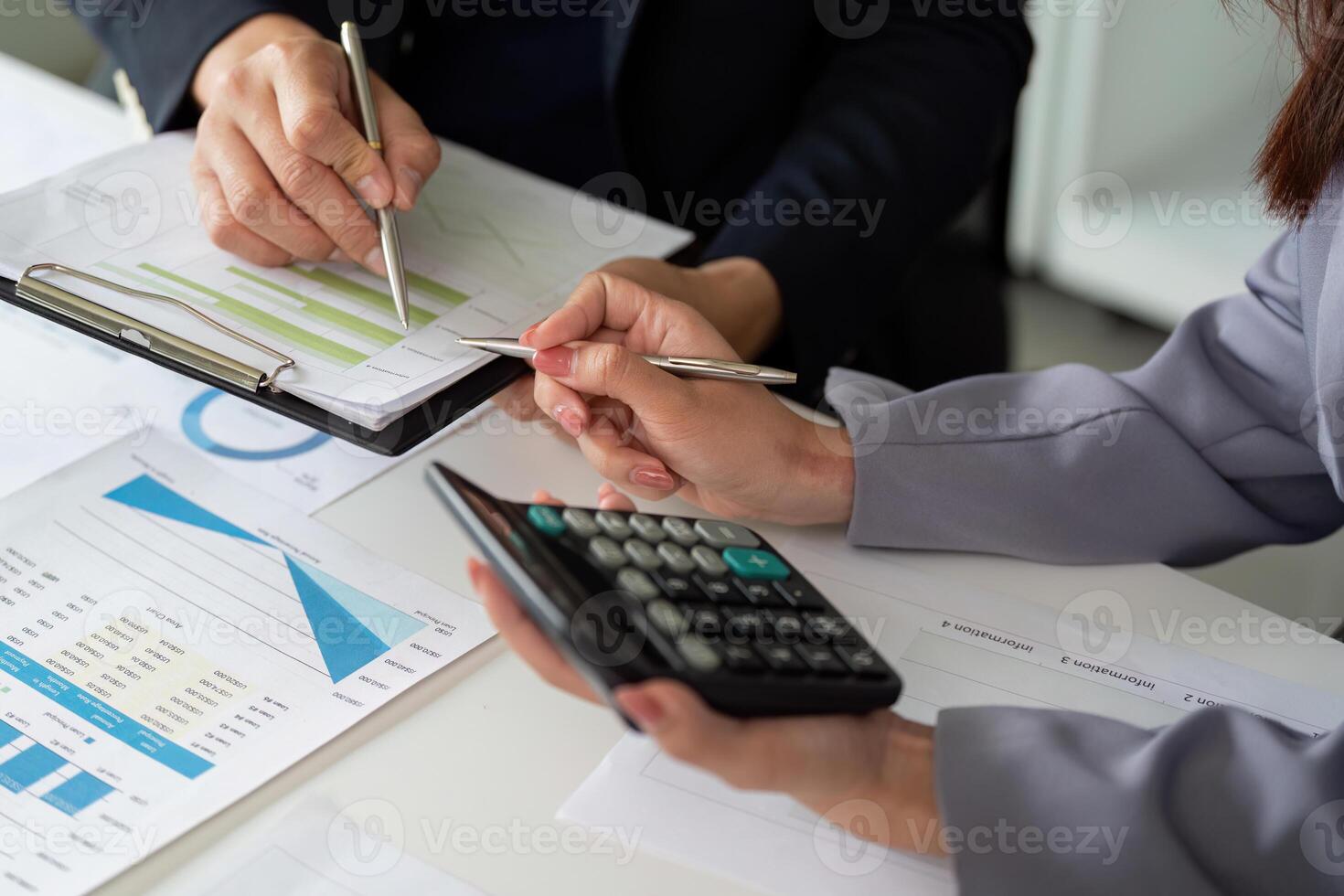 Teamwork and Financial Planning. Colleagues reviewing financial charts and calculations together. photo