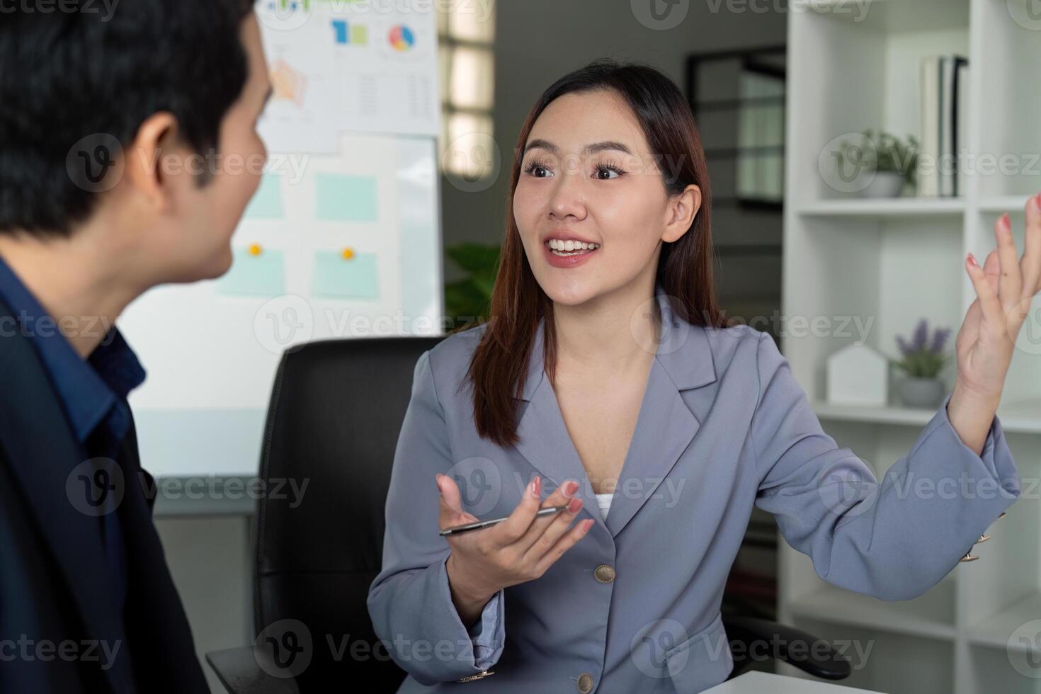 Dynamic Discussion in the Workplace. A professional woman passionately explains her ideas to a colleague. photo