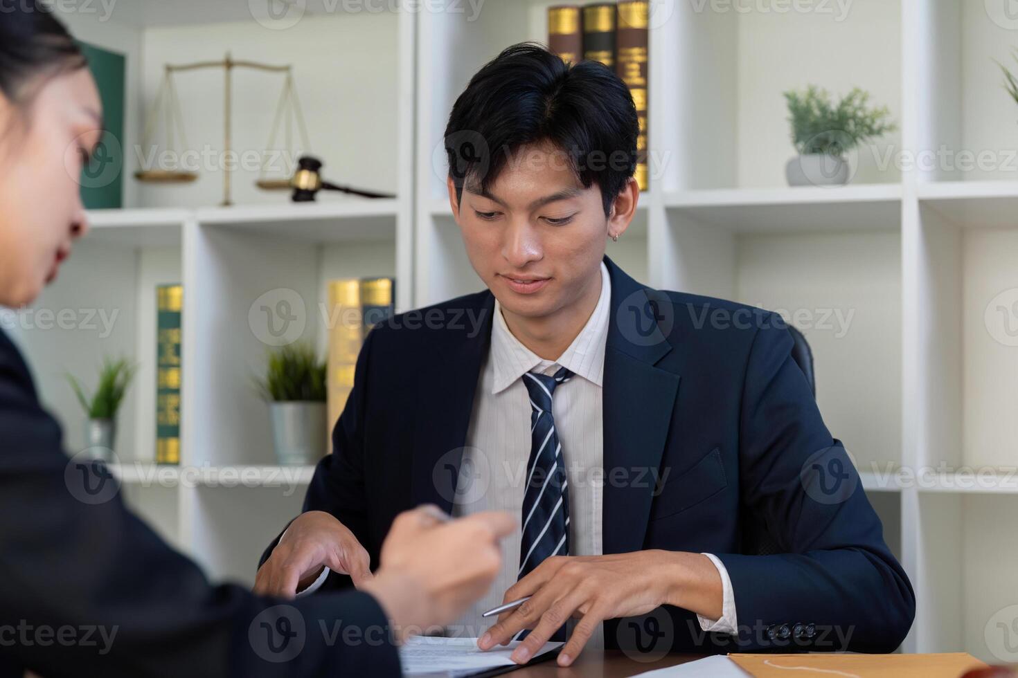 Consultation and Legal Advice. An attorney meeting with a client to review documents. photo