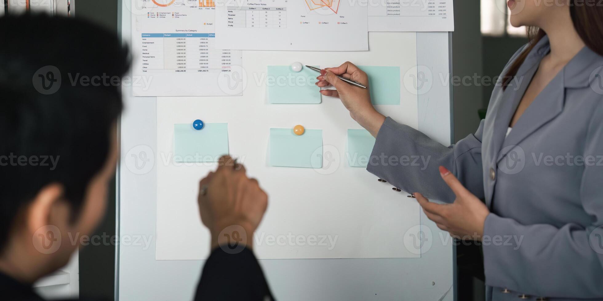 Data Analysis and Strategy. A focused discussion on performance metrics using visual aids during a team meeting. photo