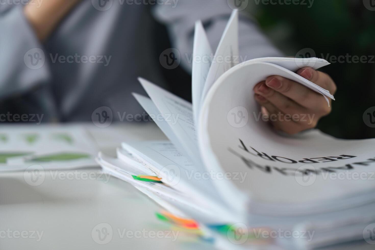 Documentation and Reporting. A professional handling multiple financial reports. photo